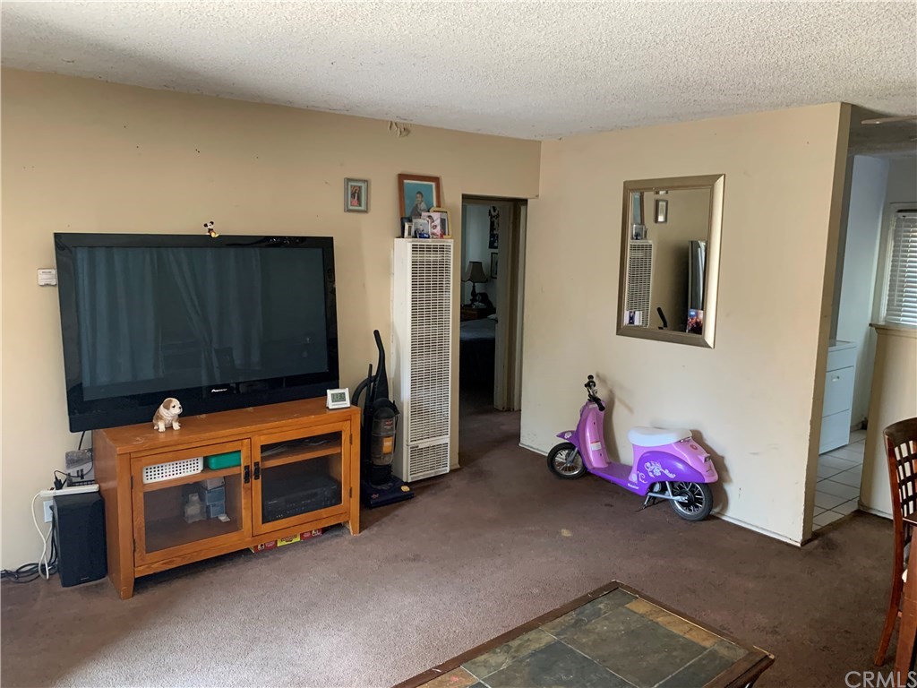 7771 Philbin Avenue Riverside, CA 92503 - Photo 23 of 30 a living room with furniture and a flat screen tv