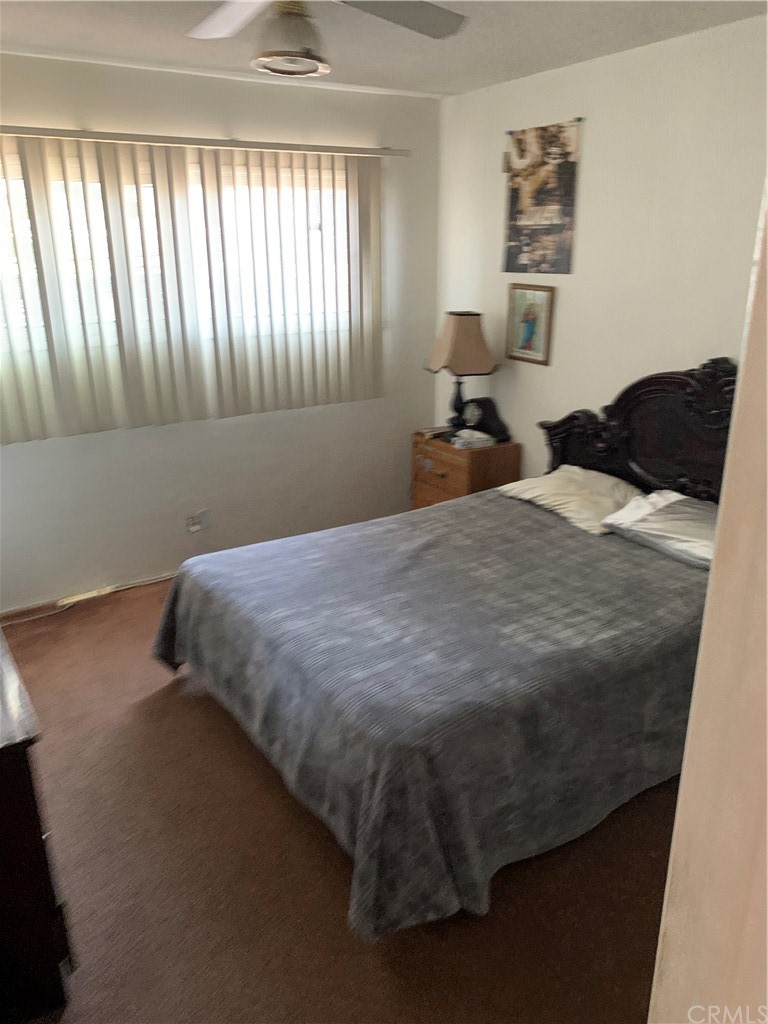 7771 Philbin Avenue Riverside, CA 92503 - Photo 27 of 30 a bedroom with a bed and window