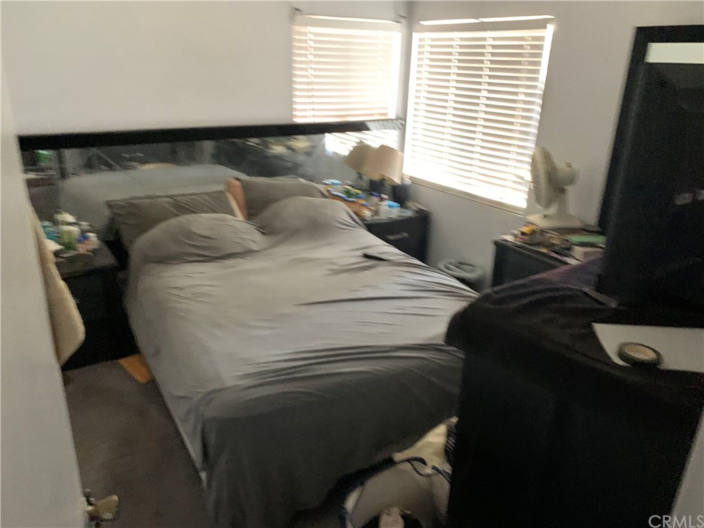 7771 Philbin Avenue Riverside, CA 92503 - Photo 6 of 30 a bed sitting in a bedroom next to a window