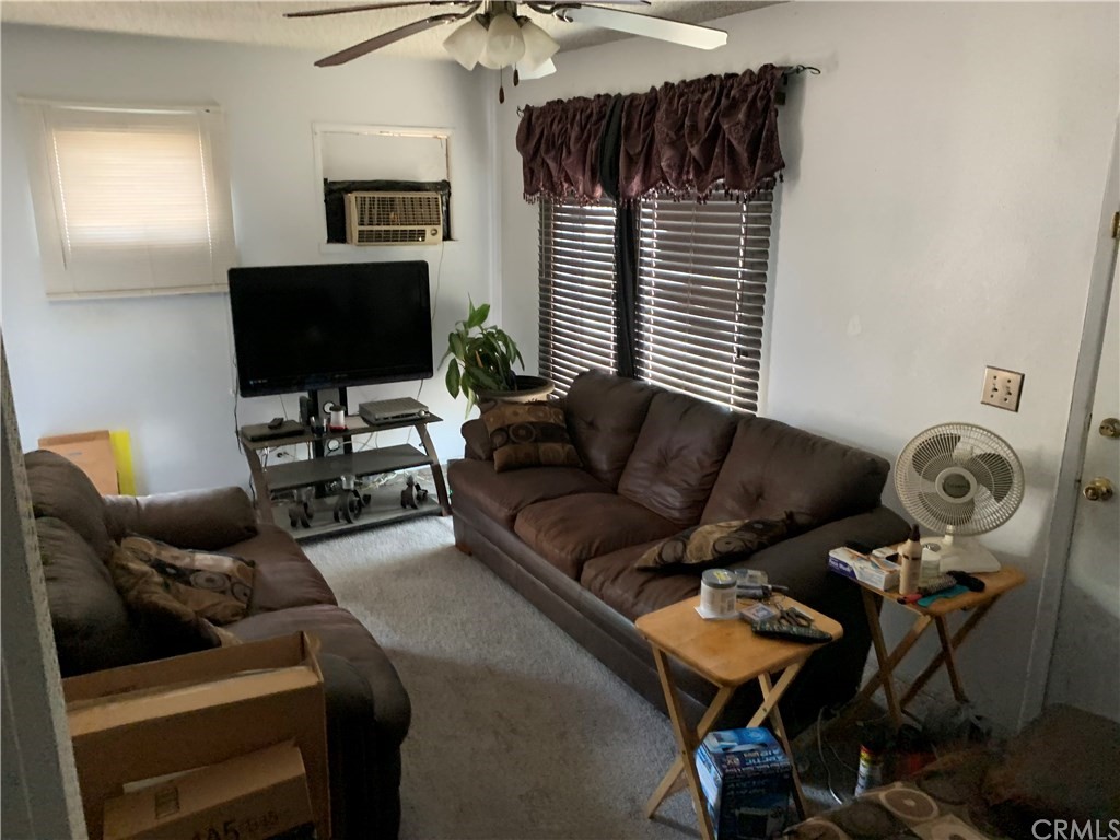 7771 Philbin Avenue Riverside, CA 92503 - Photo 8 of 30 a living room with furniture and a flat screen tv
