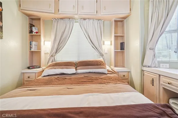 a view of walk in closet with window and wooden floor