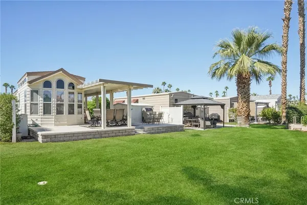 a front view of a house with a garden and plants