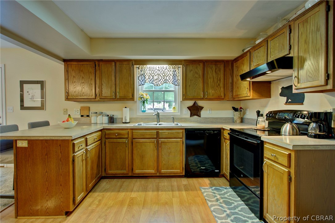 10289 Figg Shop Road Gloucester, VA 23061 - Photo 13 of 34 kitchen has ample cabinet space and pretty laminate flooring.