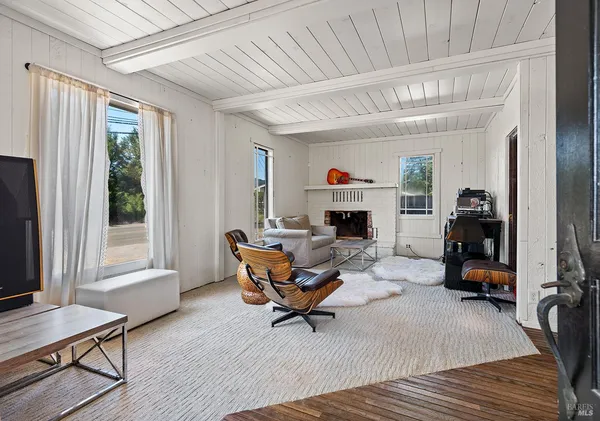 a view of a room with wooden floor and window