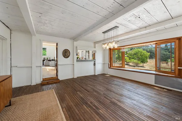 a kitchen with stainless steel appliances granite countertop a stove and a wooden floors