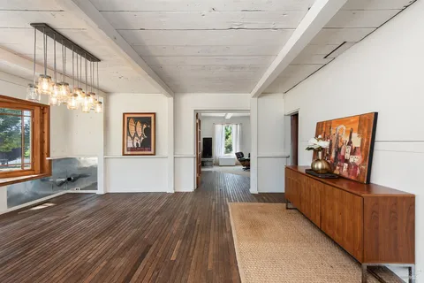a kitchen with stainless steel appliances white cabinets and a large window