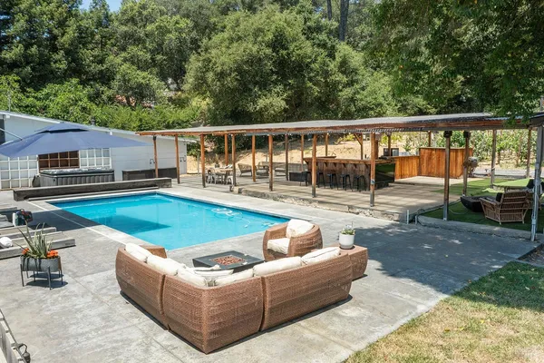 a view of a house with a backyard and a patio