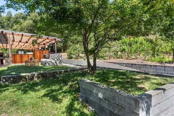 a view of a patio with a table chairs and wooden fence