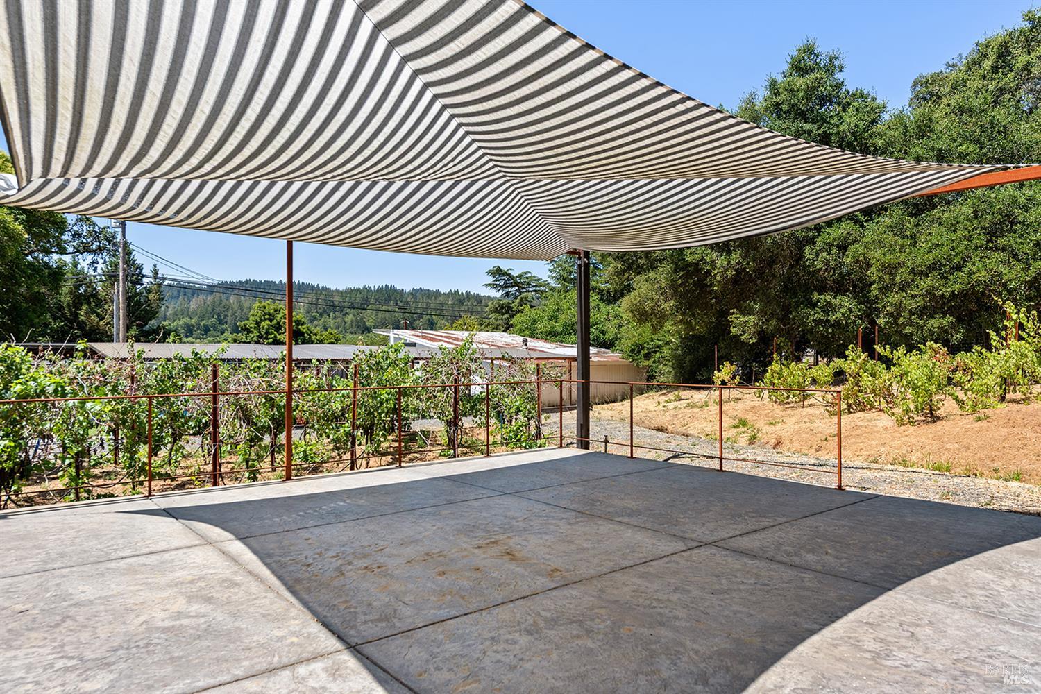 995 Dry Creek Road Healdsburg, CA 95448 - Photo 51 of 57 a view of a patio with a table chairs and wooden fence
