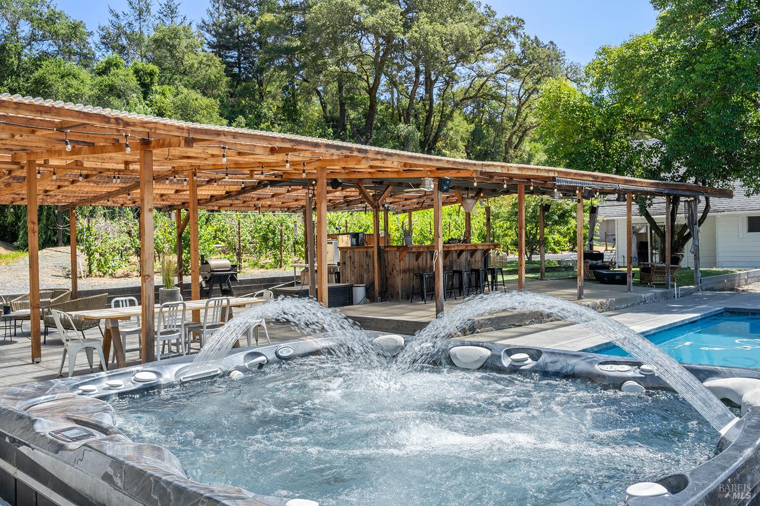 995 Dry Creek Road Healdsburg, CA 95448 - Photo 6 of 57 a view of a patio with a table and chairs under an umbrella