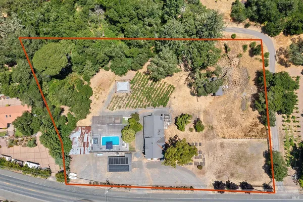an aerial view of a house with a yard and garden