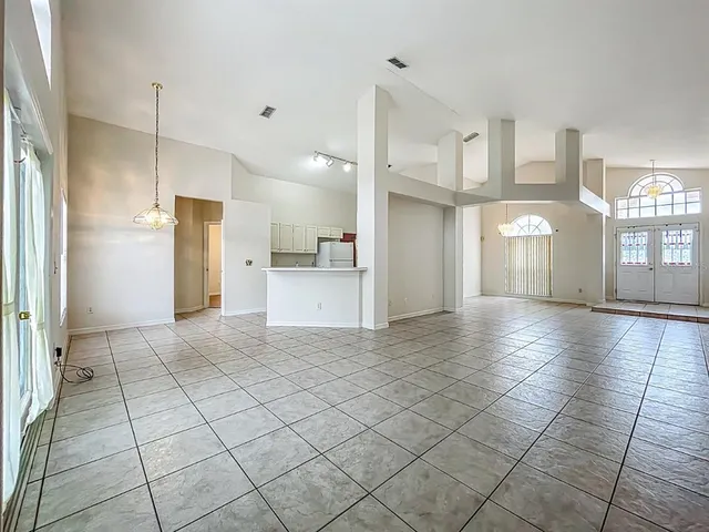 a kitchen with white cabinets stainless steel appliances and a refrigerator