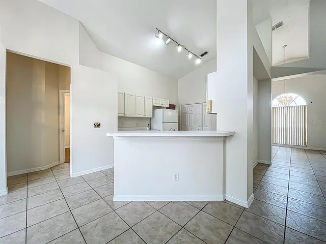 an empty room with wooden floor and a window