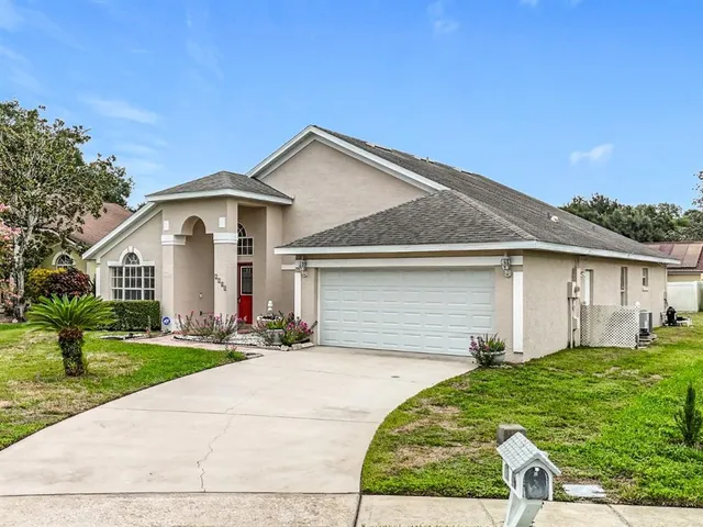 a front view of a house with a garden and yard