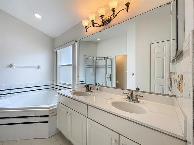 a bedroom with furniture and a large window