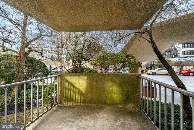 a view of a chairs and table under an umbrella in backyard