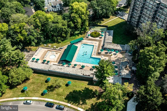 an aerial view of a house with swimming pool outdoor seating and yard