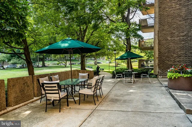 an aerial view of a swimming pool with outdoor seating