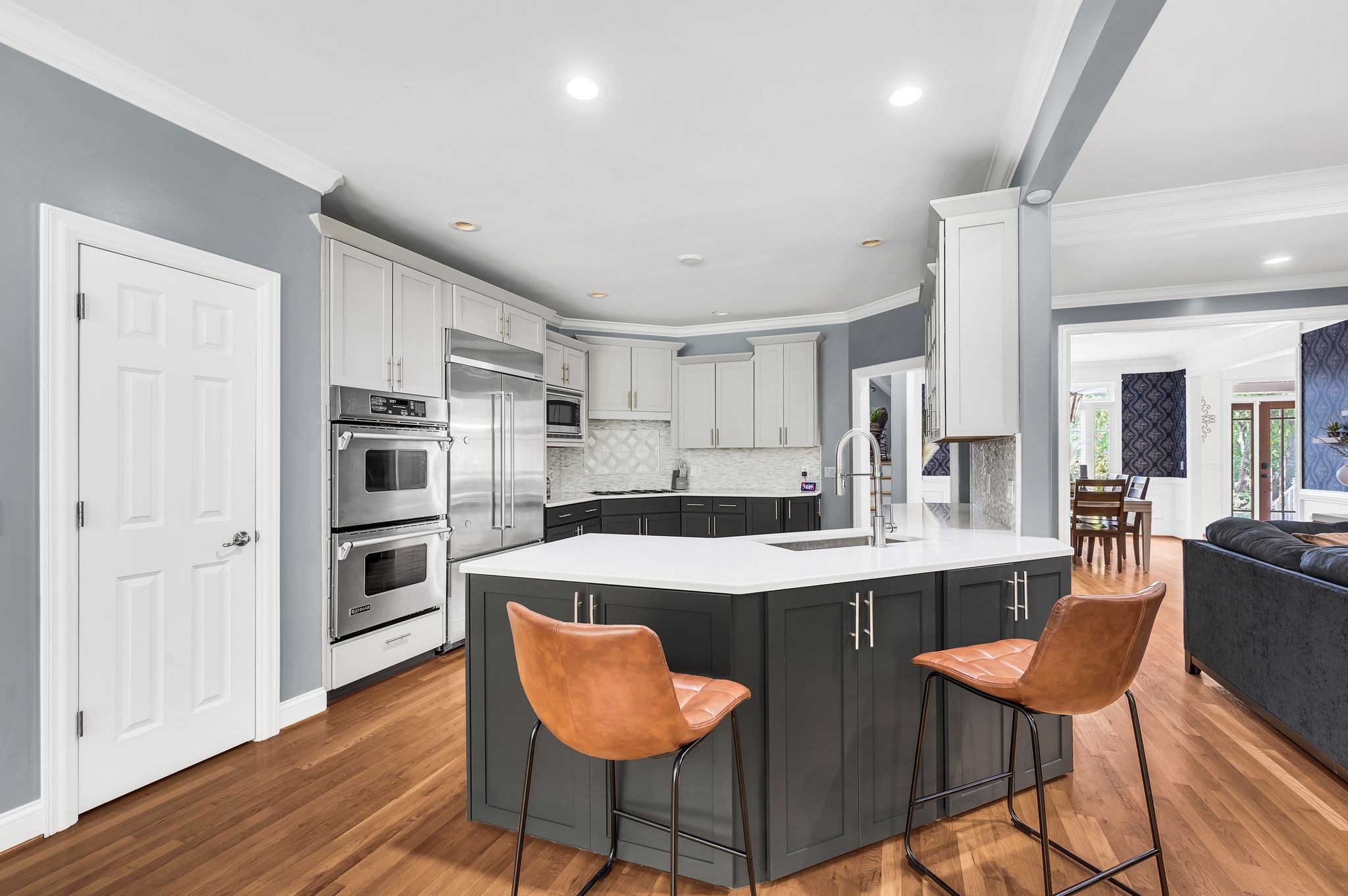149 Allenhurst Circle Franklin, TN 37067 - Photo 20 of 66 a kitchen with stainless steel appliances a dining table chairs and wooden floor