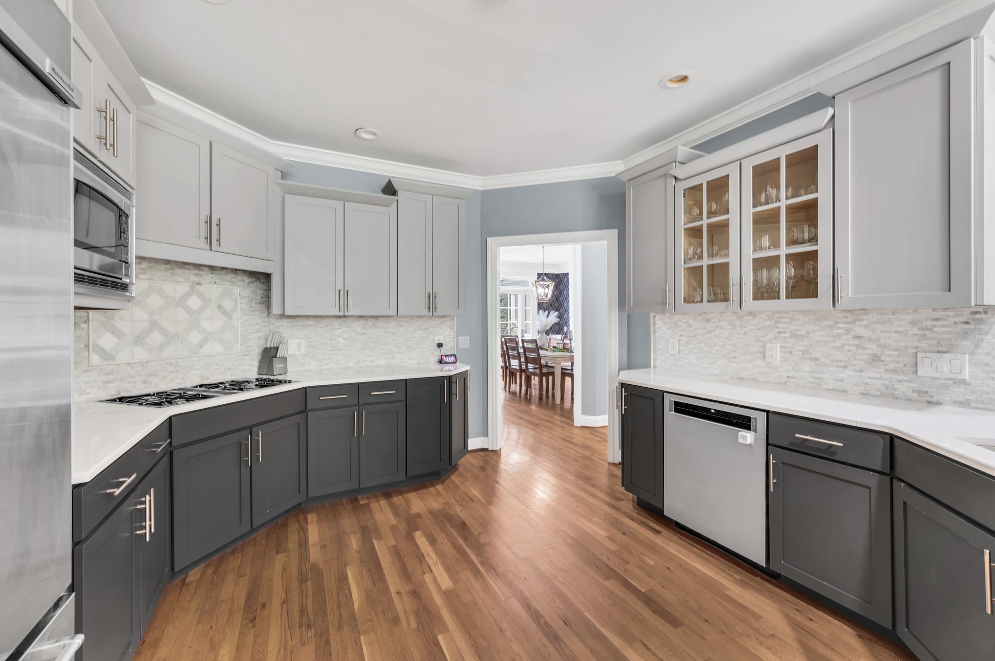 149 Allenhurst Circle Franklin, TN 37067 - Photo 23 of 66 a kitchen with stainless steel appliances granite countertop a stove a sink dishwasher and a microwave oven with wooden floor