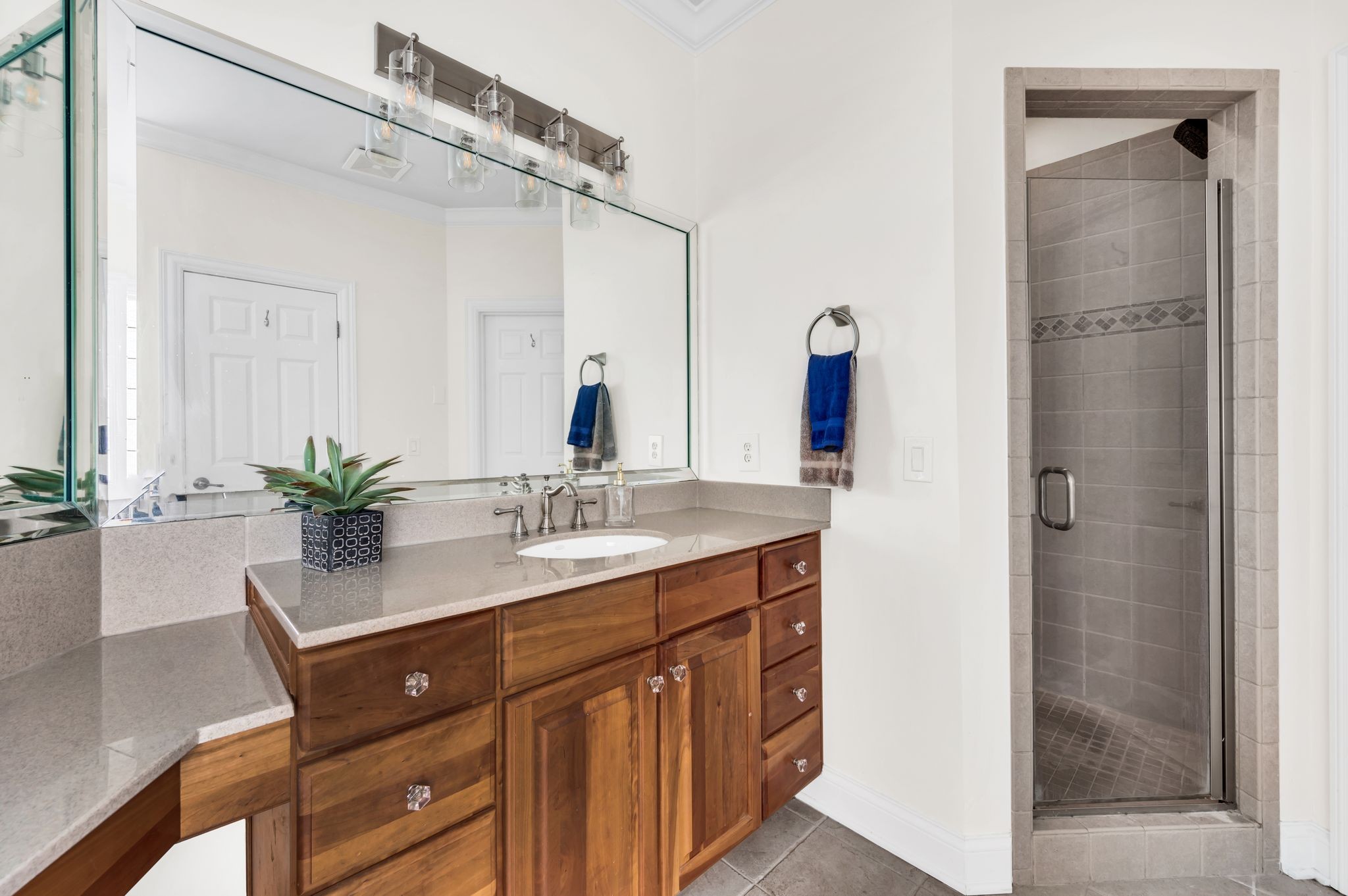 149 Allenhurst Circle Franklin, TN 37067 - Photo 37 of 66 a bathroom with a granite countertop sink a mirror and a shower