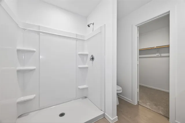 a bathroom with a shower and toilet