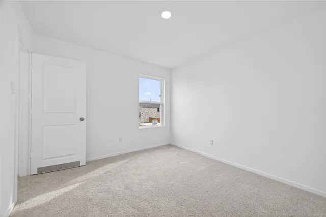 an empty room with a empty space and windows