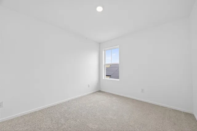 a view of an empty room and a window
