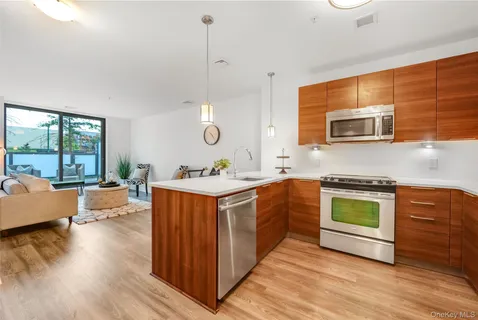 a kitchen with stainless steel appliances granite countertop wooden floors and sink