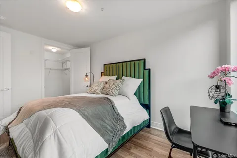 a bedroom with a bed and a chair