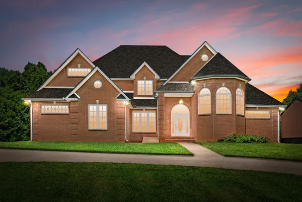 a front view of a house with a yard and garage