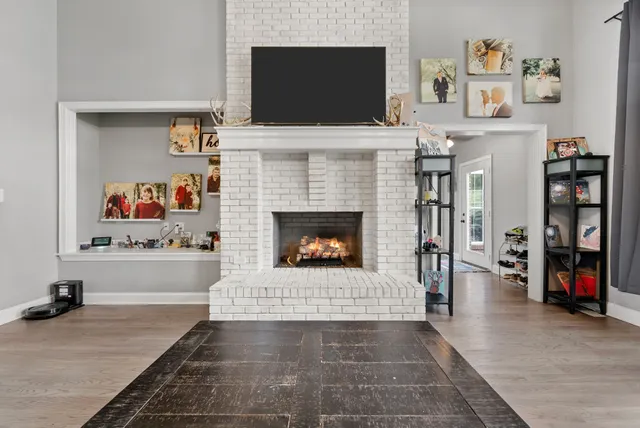 a living room with furniture and a fireplace
