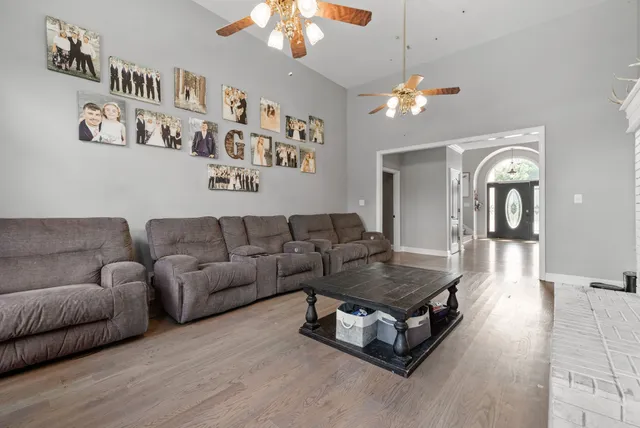 a living room with furniture and a chandelier