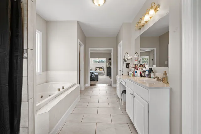 a large white kitchen with a large window