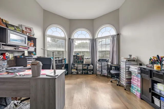 a very nice looking room with many windows and furniture