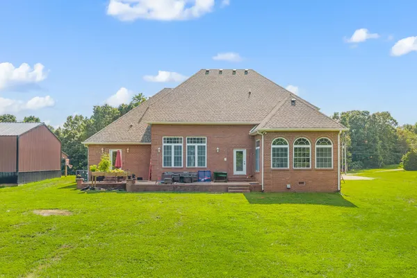 a front view of house with yard and green space