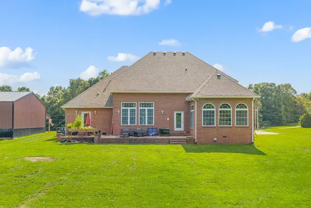 a front view of house with yard and green space