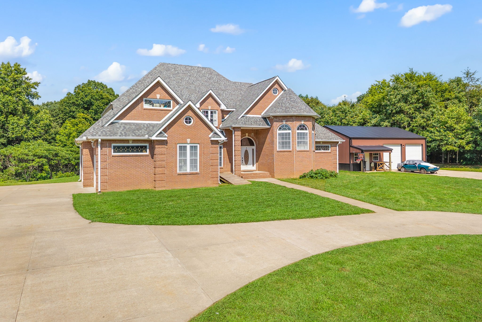 3723 Reed Road Indian Mound, TN 37079 - Photo 4 of 47 a front view of a house with a yard and garage