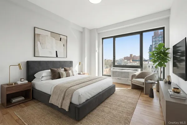 a bedroom with a bed and a large window