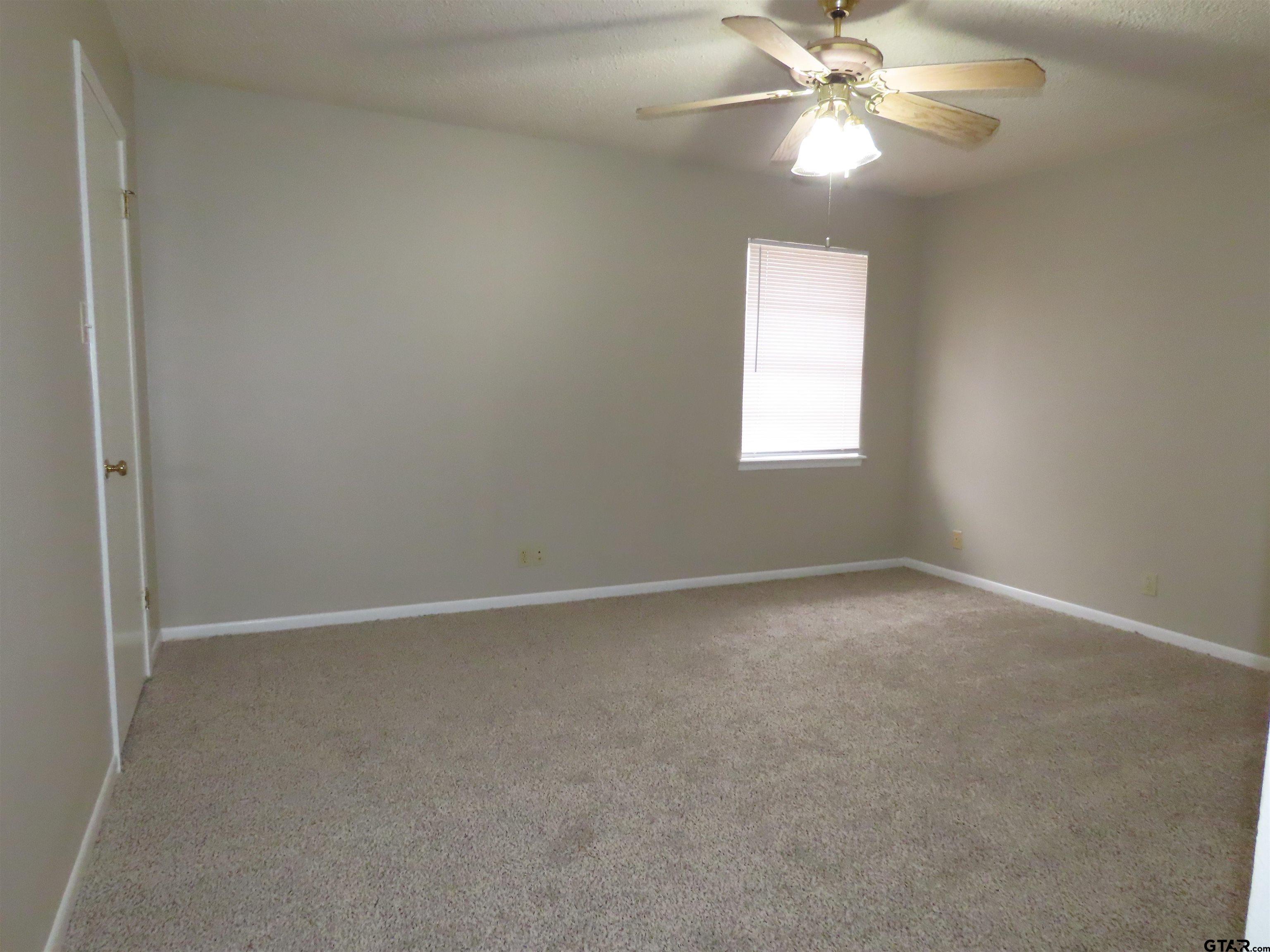 402 Muller Garden Road Tyler, TX 75703 - Photo 23 of 33 an empty room with a window and a fan