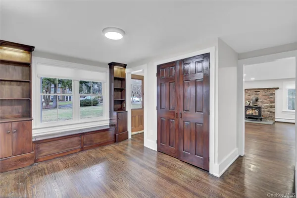 a view of a livingroom with wooden floor and furniture