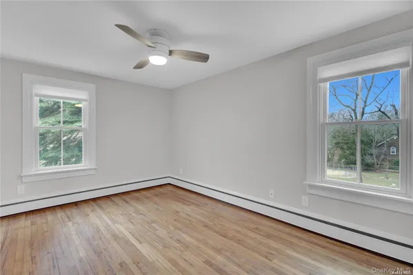 a view of a room with wooden floor and a window