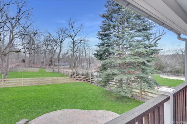 a view of a backyard with wooden fence