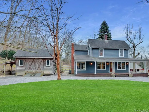 a front view of a building with a yard