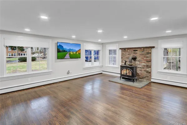 a living room with furniture wooden floor and window