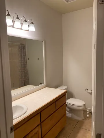 a bathroom with a toilet a sink and window