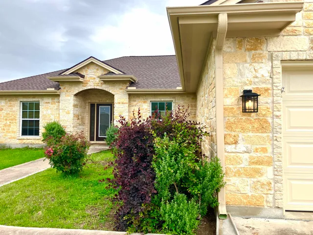 a front view of a house with garden
