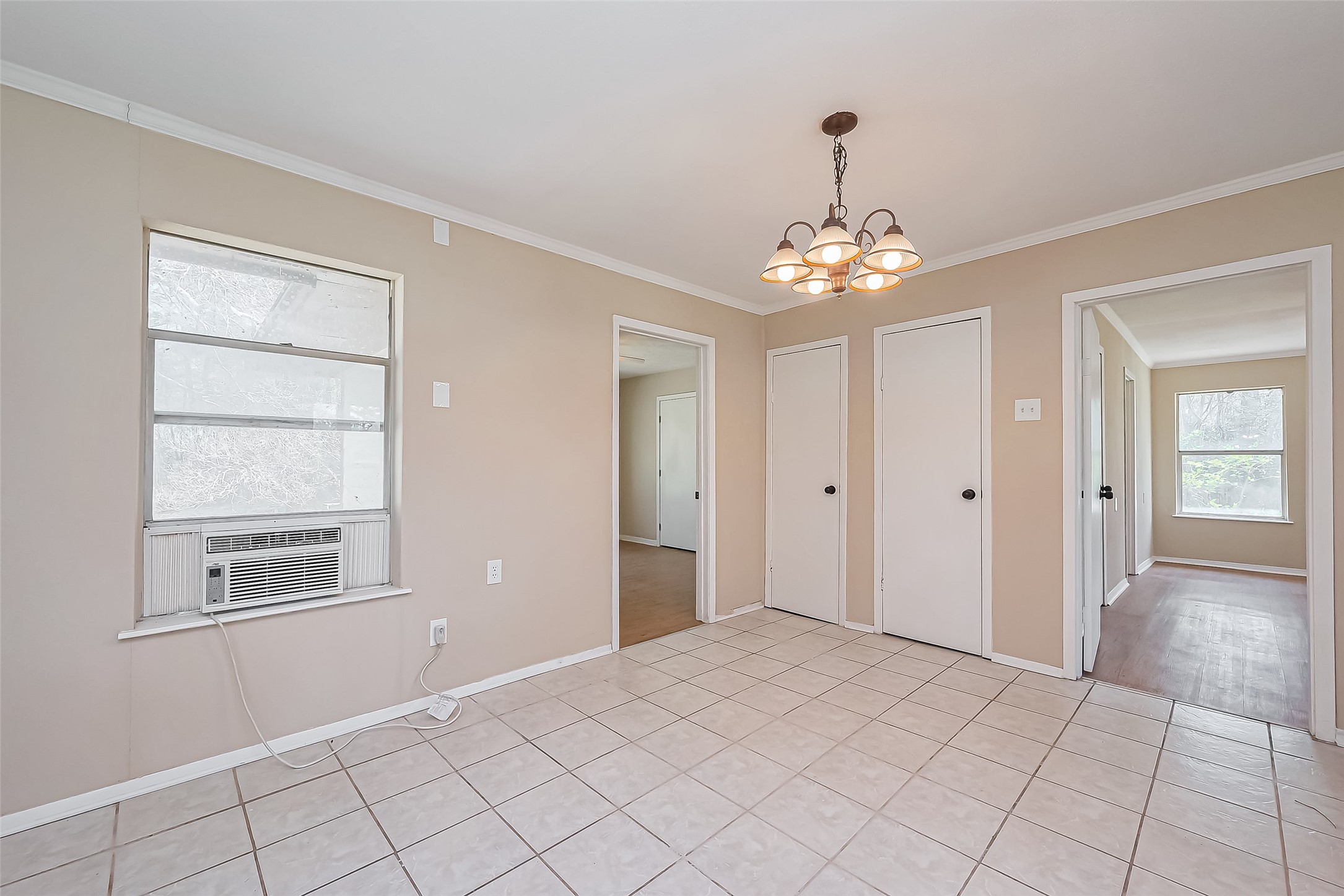 14 Veronica Lane Huntsville, TX 77340 - Photo 15 of 50 a very nice looking room with a chandelier fan and windows