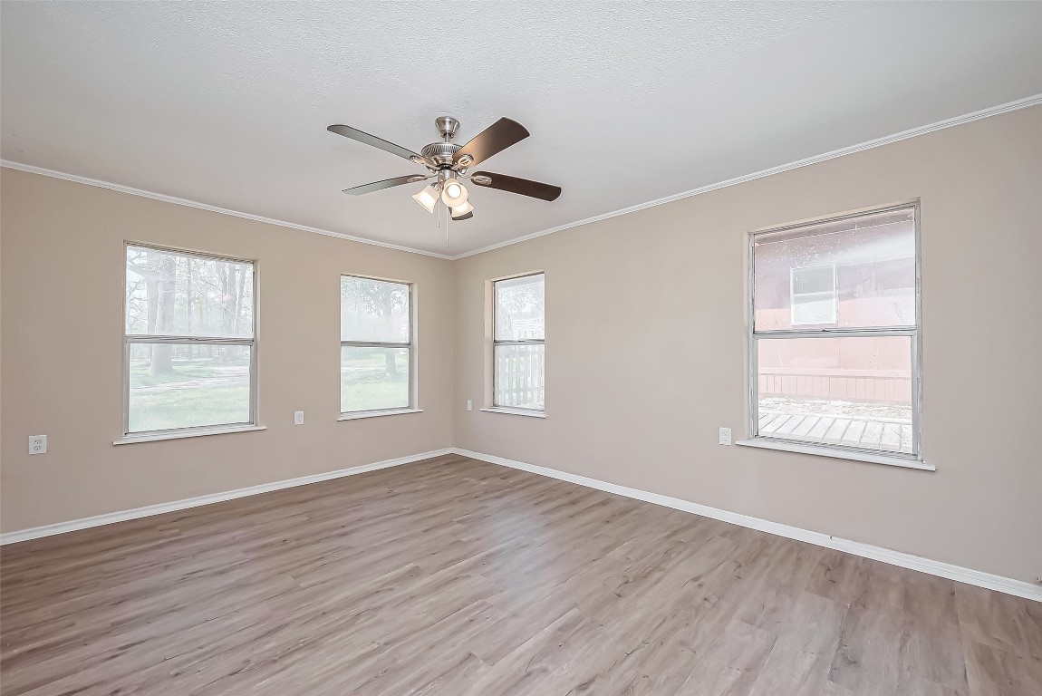 14 Veronica Lane Huntsville, TX 77340 - Photo 16 of 50 a view of an empty room with a window and wooden floor
