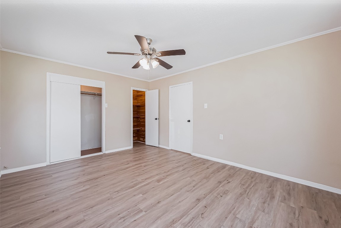 14 Veronica Lane Huntsville, TX 77340 - Photo 18 of 50 a view of an empty room with wooden floor and a ceiling fan